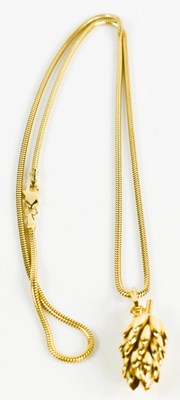Lot 258 - A 14k gold pendant necklace, the snake link...