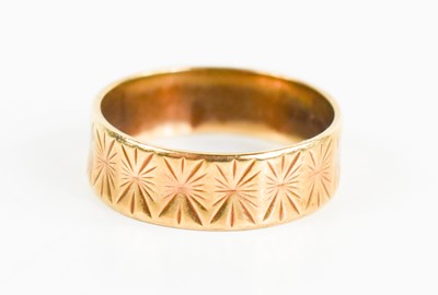 Lot 238 - A 9ct gold wedding band, engraved with...