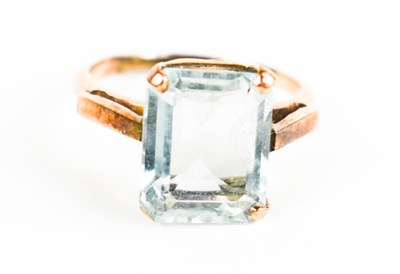 Lot 208 - A gold and aquamarine ring, the emerald cut...