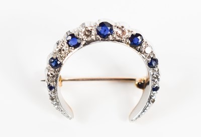 Lot 20 - A 9ct gold, diamond and sapphire crescent moon...