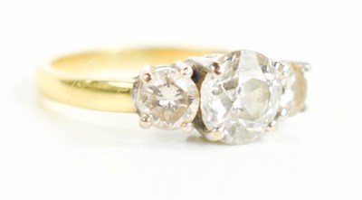 Lot 184 - An 18ct gold and three stone diamond ring, the...