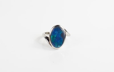 Lot 215 - A black opal and precious metal ring, the oval...