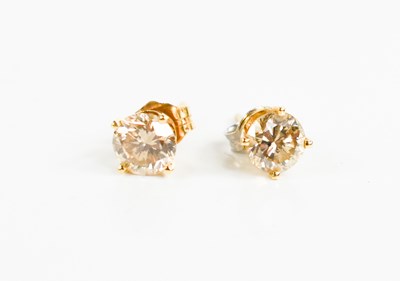 Lot 176 - A pair of champagne diamond stud earrings,...