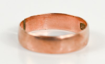 Lot 112 - A 9ct rose gold wedding band (cut), size N,...