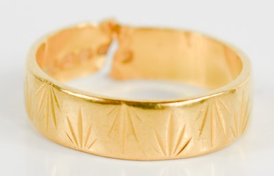 Lot 211 - A 22ct gold wedding band (cut), engraved with...
