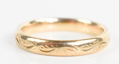 Lot 137 - A 9ct gold wedding band, engraved with...