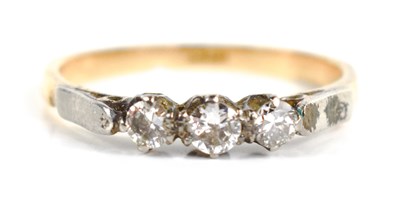 Lot 95 - An 18ct gold three stone diamond ring, the...