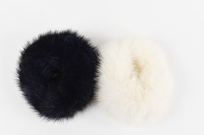Lot 107 - A pair of mink hair bobbles: one in cream, the...