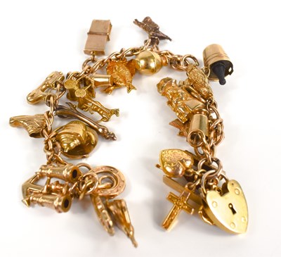 Lot 191 - A 9ct gold charm bracelet, with twenty six...