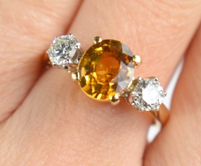Lot 26 - An 18ct gold, Imperial topaz and diamond ring,...