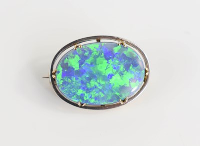 Lot 27 - A white gold and black opal brooch, the oval...