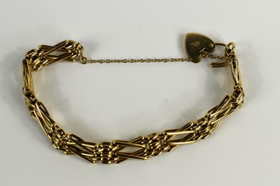 Lot 84 - A 9ct gold X link bracelet with padlock form...