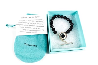 Lot 72 - A Tiffany & Co. beaded bracelet with white...