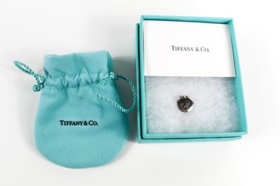 Lot 63 - A Tiffany & Co. circular silver charm...
