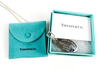 Lot 82 - A Tiffany & Co. oval dog tag pendant necklace...