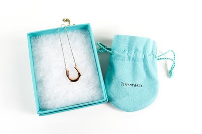 Lot 78 - A Tiffany & Co. silver horse shoe pendant...