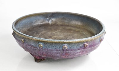 Lot 312 - A Chinese purple glazed bowl raised on three...