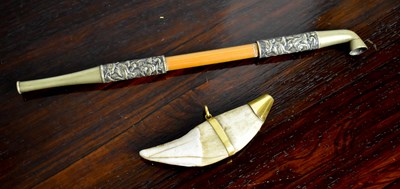 Lot 115 - A 19th century sea lion tooth, with brass cap...