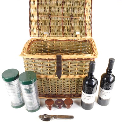 Lot 345 - A wicker picnic basket containing two bottles...
