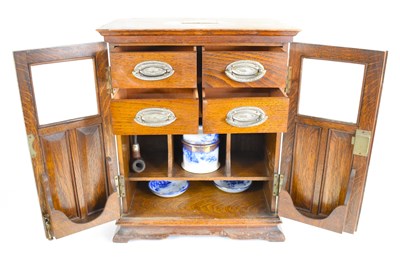 Lot 366 - An early 20th century oak smokers cabinet,...