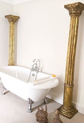 Lot 394 - Two large giltwood Ionic columns, in the...