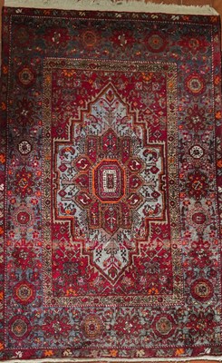 Lot 326 - A Middle Eastern red ground wool rug, with...