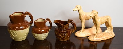 Lot 176 - Three stoneware Victorian jugs, with greyhound...