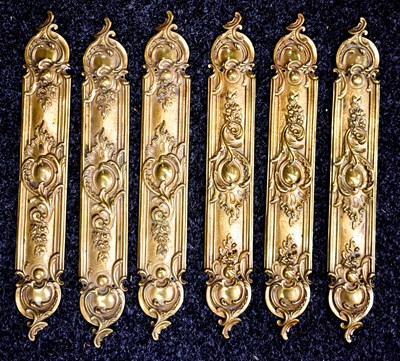Lot 297 - A set of six French brass door plates, in the...