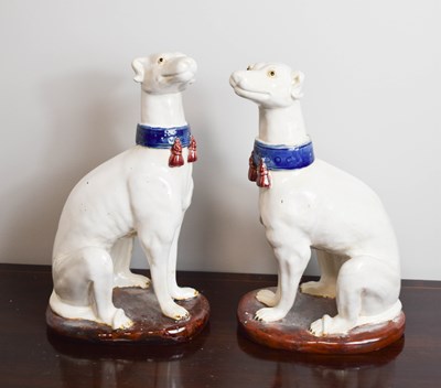 Lot 179 - A pair of pottery 20th century dogs, wearing...