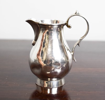 Lot 213 - A silver milk jug, London 1920, with scroll...