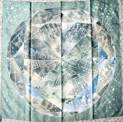 Lot 164 - A Hermes silk scarf, in pale green with clock...