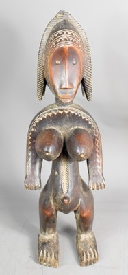 Lot 305 - An African carved hardwood figure of a female,...