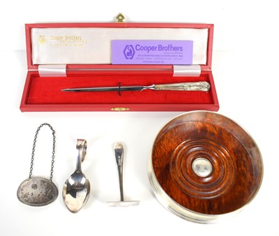 Lot 331 - A silver wine coaster with wooden base,...