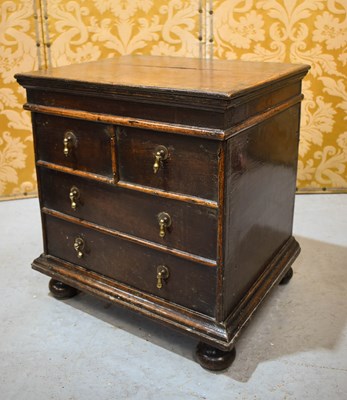 Lot 388 - An 18th century oak box, with four faux...