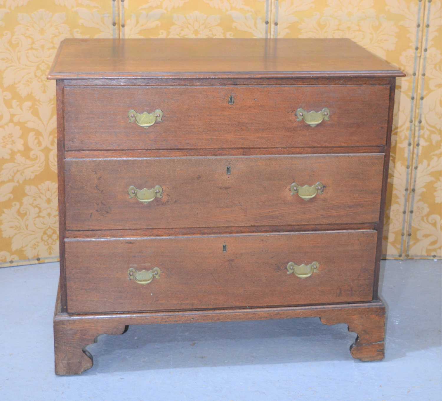 Lot 386 - An early 19th century oak chest of three...