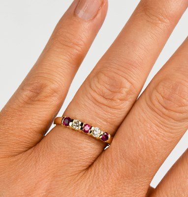 Lot 430 - A 9ct gold, ruby and diamond ring, the three...