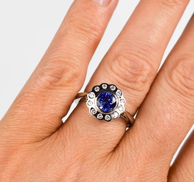 Lot 446 - An 18ct white gold sapphire and diamond...