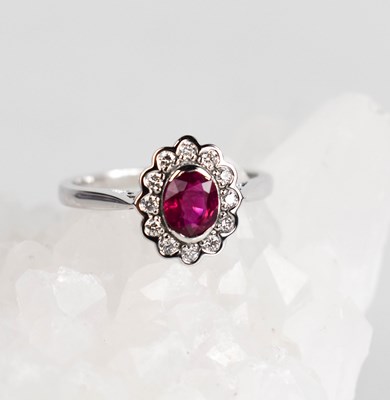 Lot 445 - An 18ct gold, ruby and diamond cluster ring,...