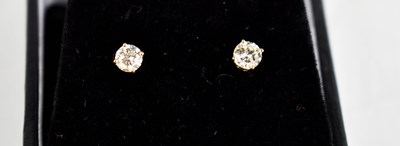 Lot 439 - A pair of diamond solitaire 18ct gold earrings.