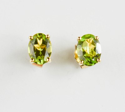 Lot 395 - A pair of 9ct gold and oval peridot stud...