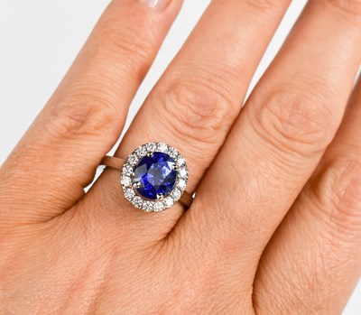 Lot 451 - A platinum, sapphire and diamond cluster ring,...