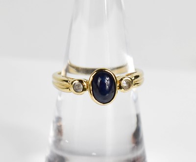 Lot 389 - A 9ct yellow gold cabochon sapphire and...