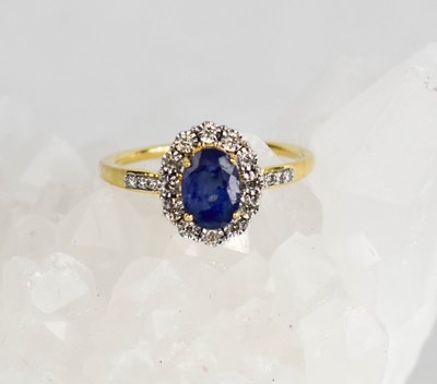 Lot 406 - A 9ct gold , sapphire and diamond cluster ring,...