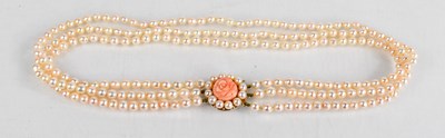 Lot 387 - A pearl, coral and 9ct gold clasp triple...