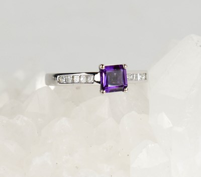 Lot 436 - An 18ct white gold amethyst and princess cut...