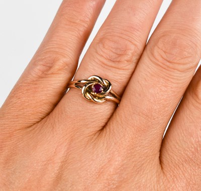 Lot 386 - A 9ct gold vintage knot ring, set with rubies,...