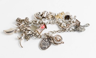 Lot 320 - A silver charm bracelet with nineteen various...