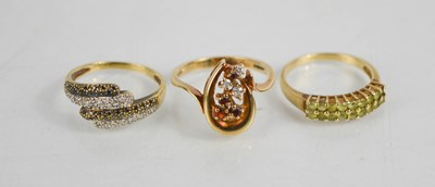 Lot 402 - A 9ct gold and diamond dress ring set with two...