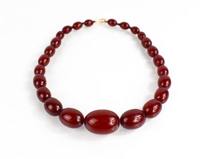 Lot 363 - A 9ct gold and red amber beaded necklace, the...