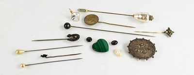 Lot 335 - A group of hat pins including silver horseshoe...